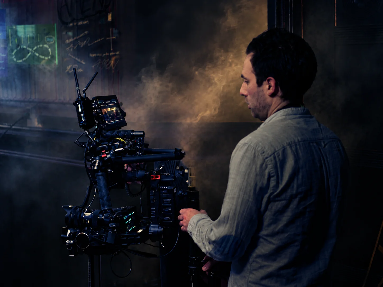 Jullian operating a cinema camera on set